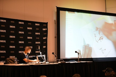 Jim Lee sketches an iconic DC character while discussing his career with the audience at the Jim Lee Comic Experience