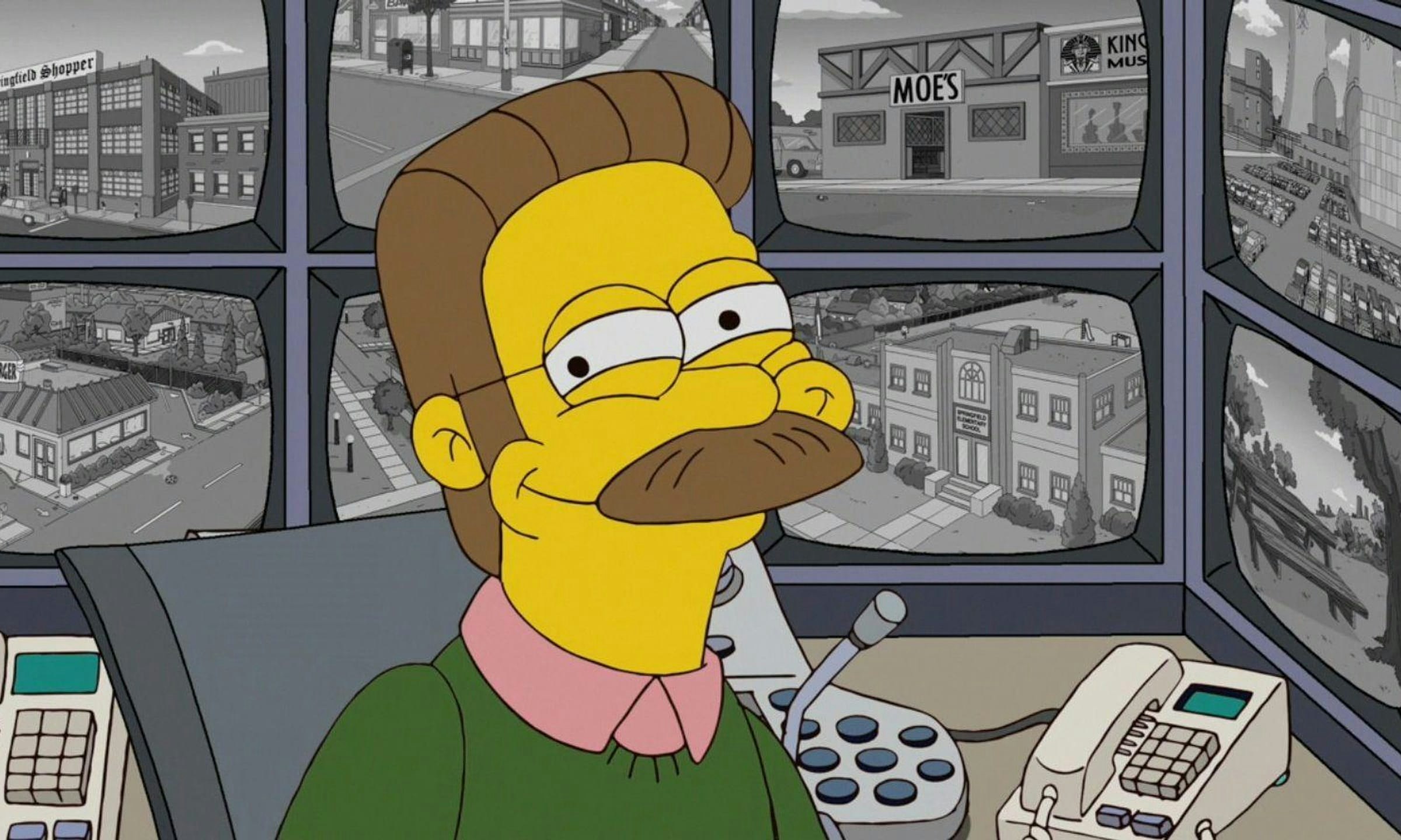 Ned wears a huge smile as he sits in front of eight visible security screens featuring various Springfield landmarks