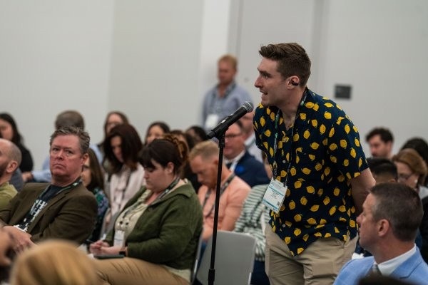 WasteExpo exhibitor explaining his product to an attendee