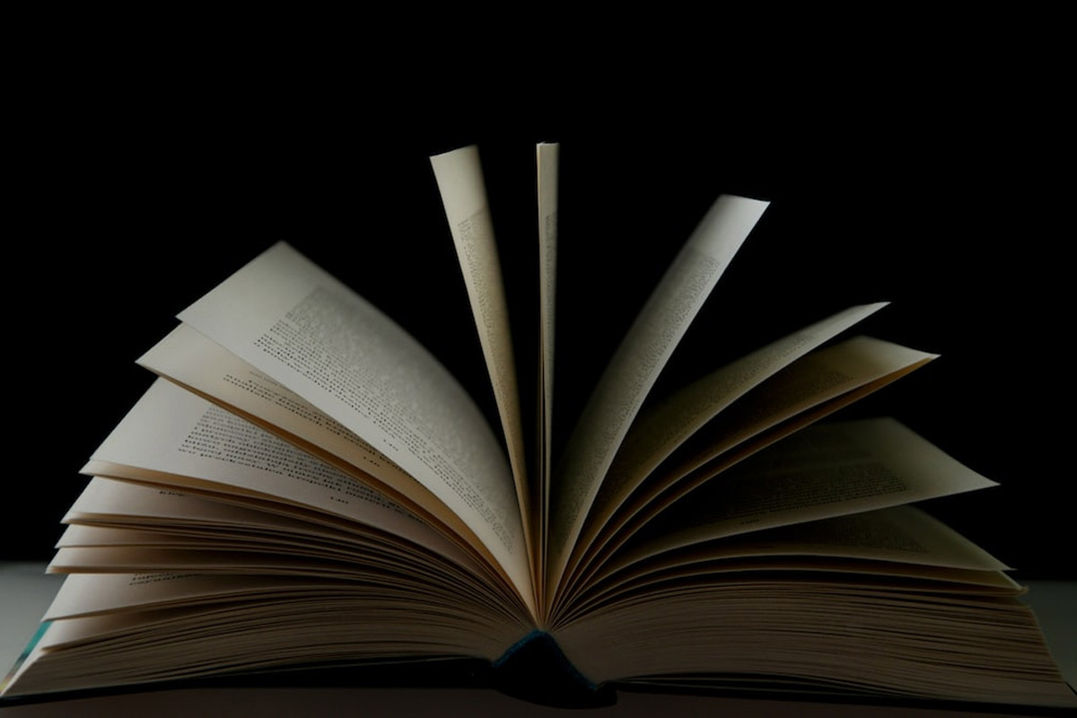 An open book with a dark black background