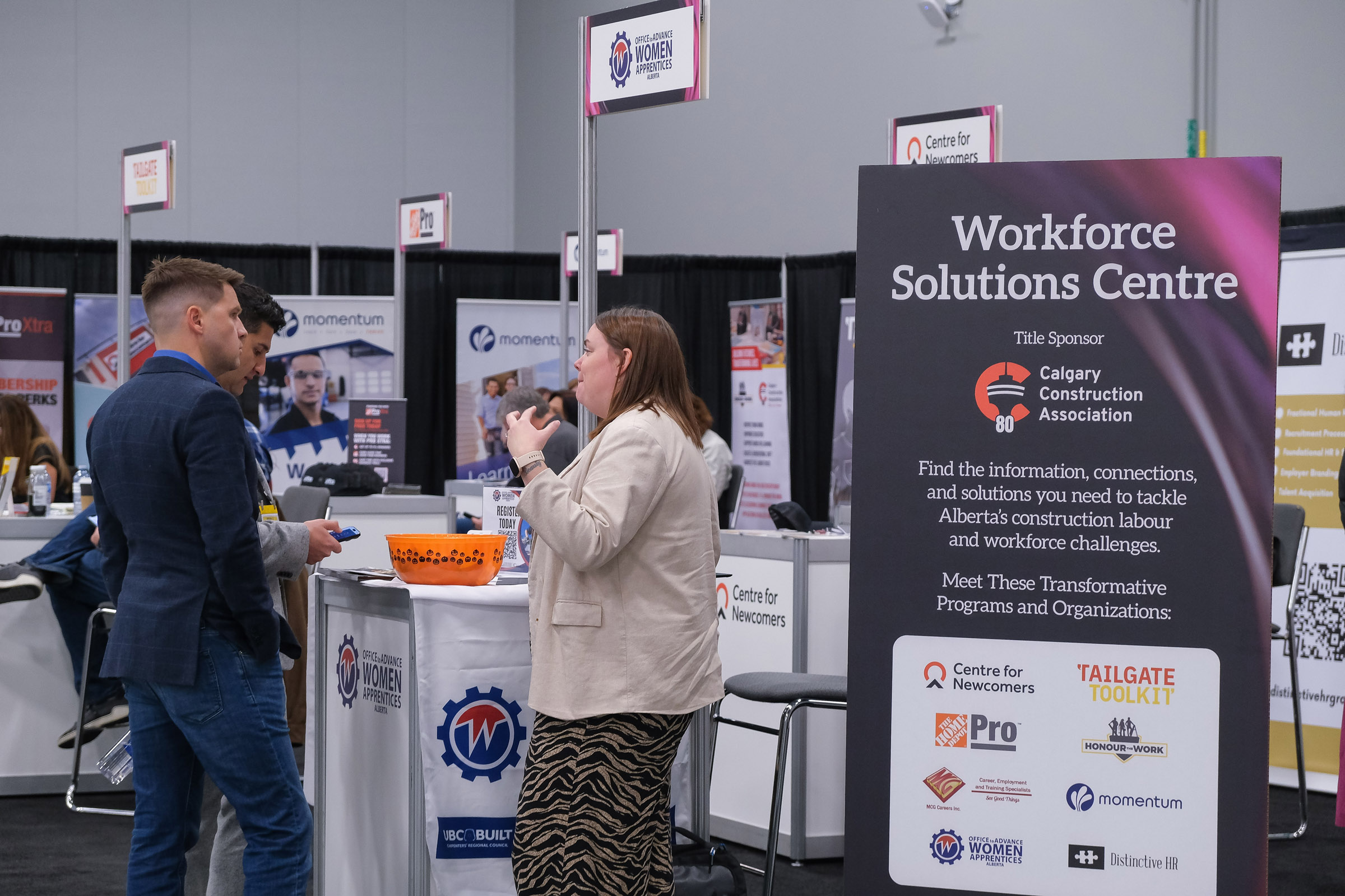 Attendees engaging in conversations at multiple kiosks as part of the 2024 Workforce Solutions Centre at BUILDEX