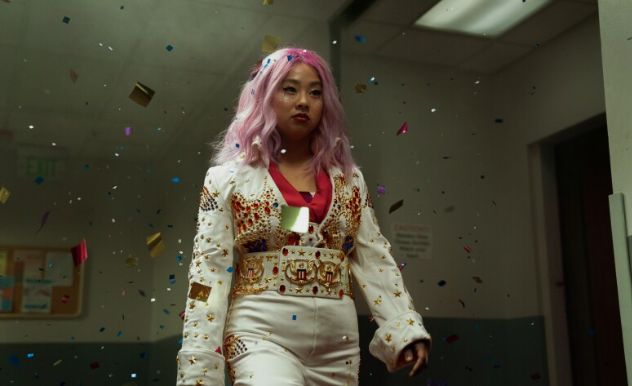 Determined girl marches through a cloud of confetti defiantly