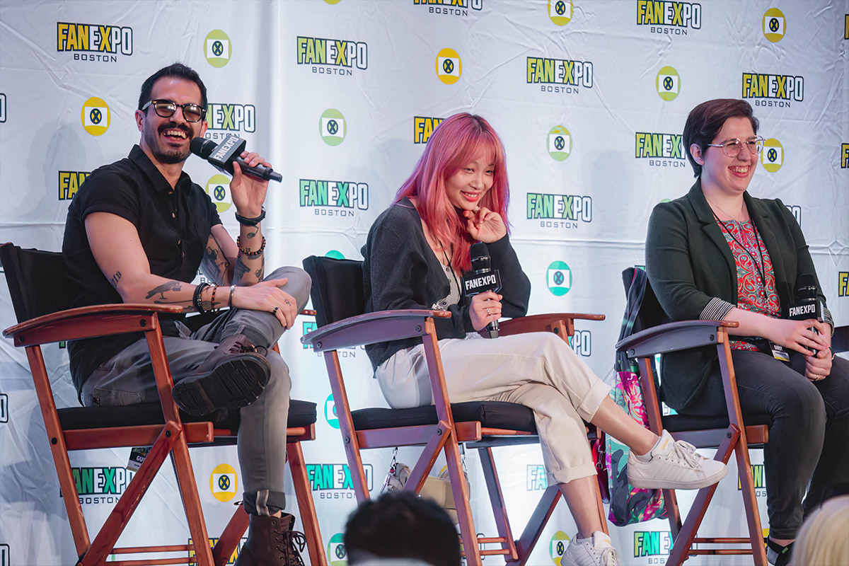 Ryan, Suzie, and Natalie from Chainsaw Man smile on stage