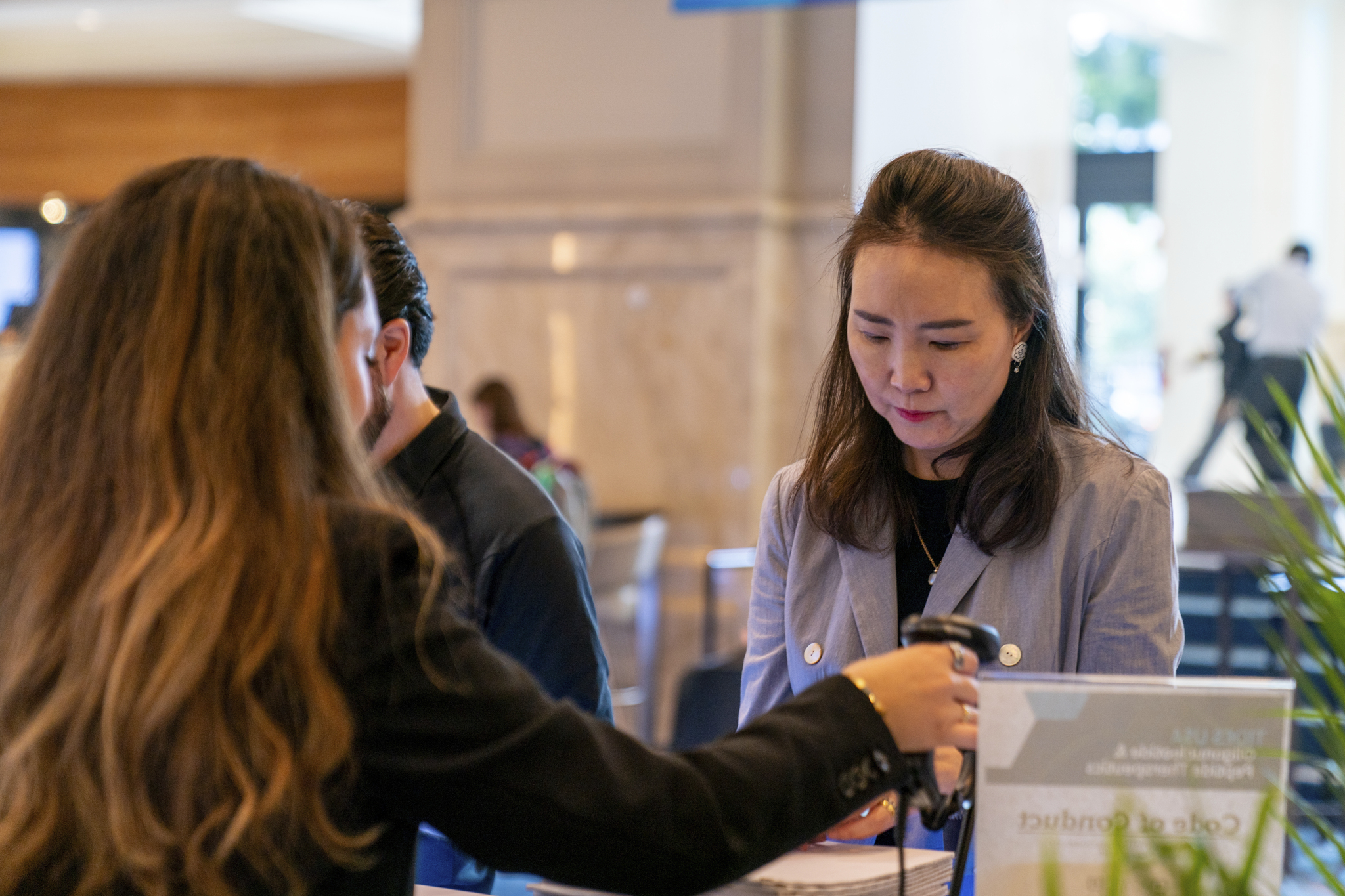 A lady checking in at TIDES USA reception