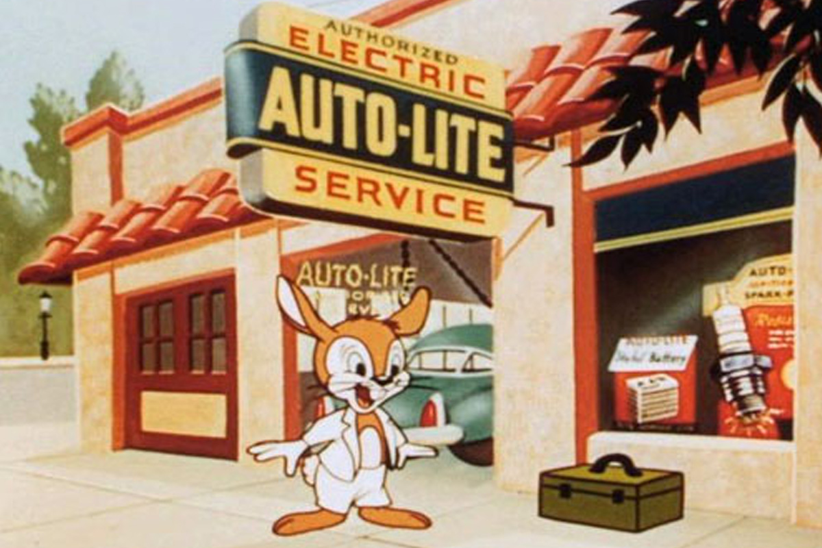 Oswald stands in front of an auto-repair store with orange fur and a white suit jacket