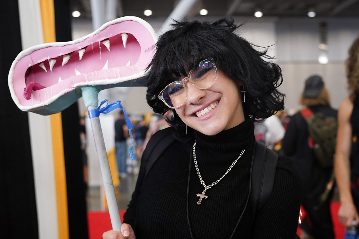 a cosplayer smiles at the camera