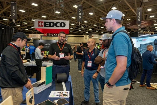 Attendees discussing products on the Build Show LIVE show floor