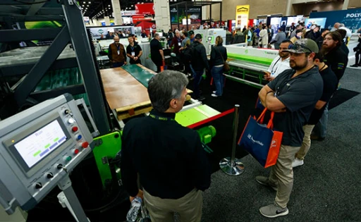 Roofing contractors discussing machinery with suppliers on the IRE show floor