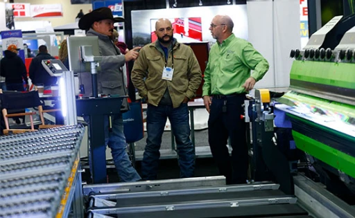 Roofing contractors looking at equipment on the IRE show floor
