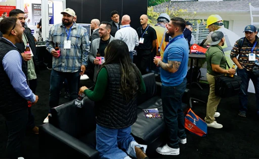 Roofing companies speaking with customers on the IRE show floor