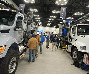 Group of attendees on the expo floor looking at trucks
