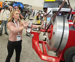Women showing product to attendees on the expo floor