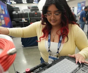Women working on a product on the expo floor
