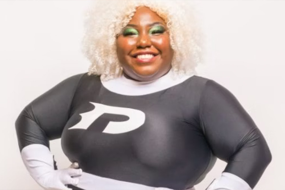 A cosplayer dressed as Danny Phantom smiles for the camera