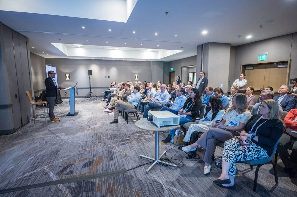 Room of people listening to a CRU speaker