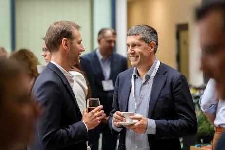 Two men chatting at networking break