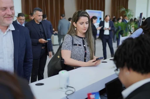 Attendees waiting in line at the event registration counter.
