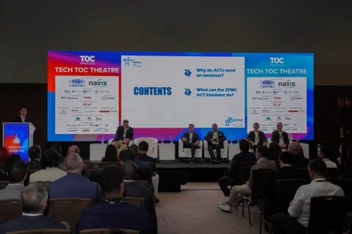 Panel session taking place at the TOC Theatre with audience seated.