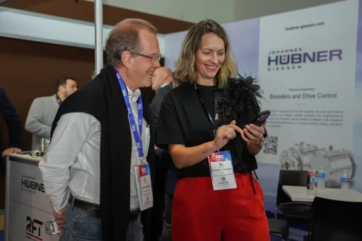 Event participants interacting at an exhibition stand.