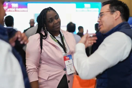 Participants discussing business at the exhibition area.