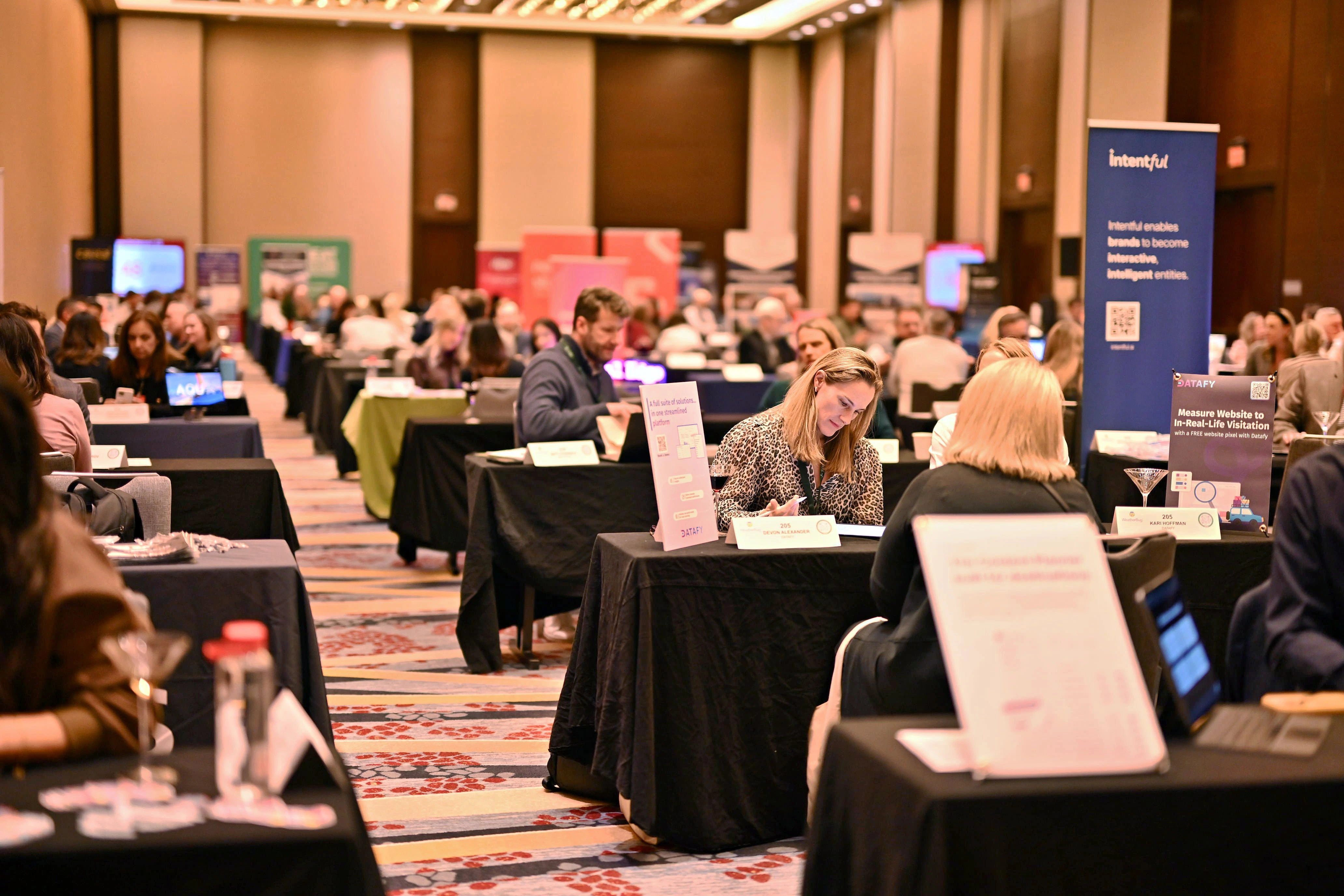 An exhibitor conducting a meeting in her trade show booth