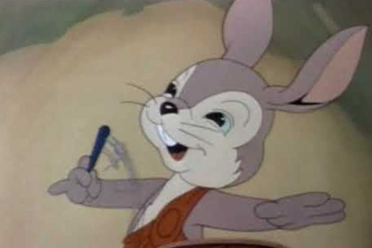 Oswald, completely. unrecognizable in grey fur and red overalls, conducts a band