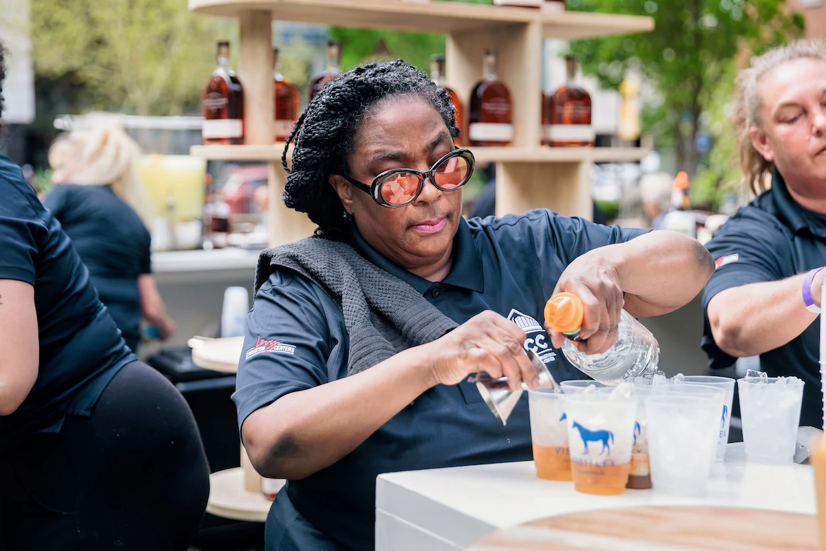 Bartender pouring drinks at the Kentucky Table lunch.