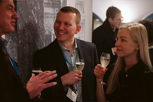 Delegates smiling and networking over champagne at the Evening Reception, World Ethanol & Biofuels 2025 in Brussels, Belgium