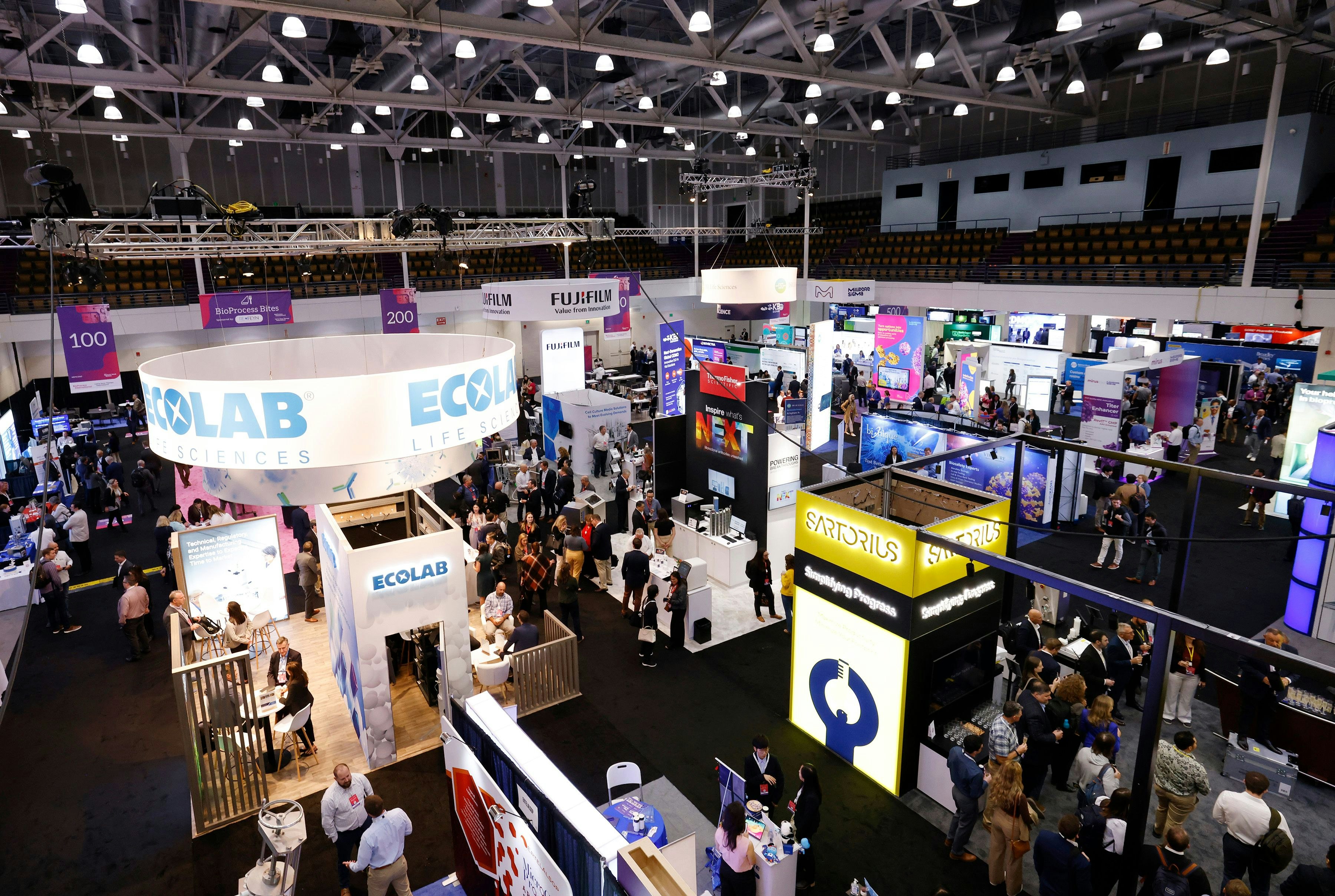 Bird's-eye view of the BioTech Week Boston exhibit hall, companies such as Sartorius and Ecolab are displayed.