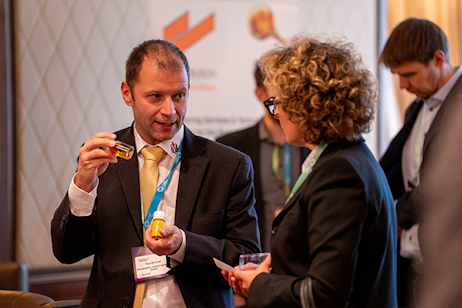 Delegates in business discussion at World Ethanol & Biofuels 2025 exhibition in Brussels, exploring biofuels technologies and sponsorship.