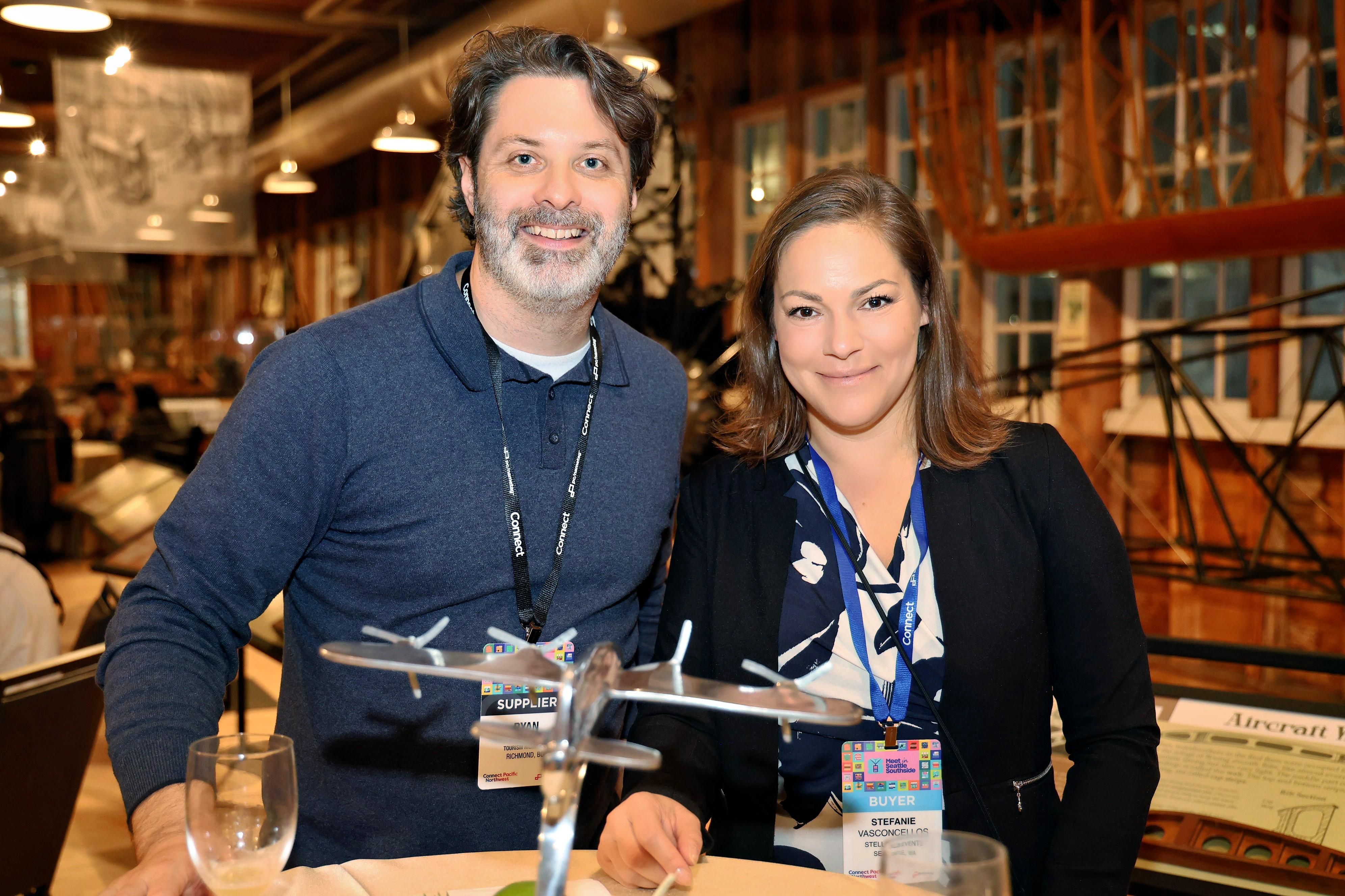 Two attendees at the Museum of Flight Opening Reception smiling.