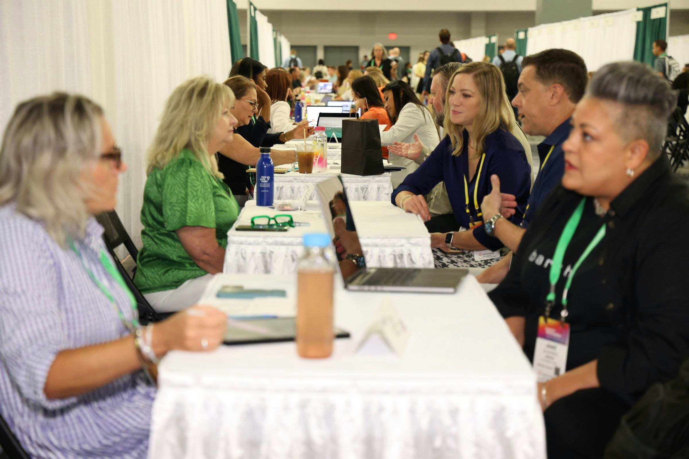 A row of event professionals meeting and taking marketplace appointments.