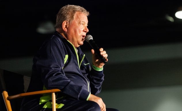 William Shatner looks serious as he answers a question on stage