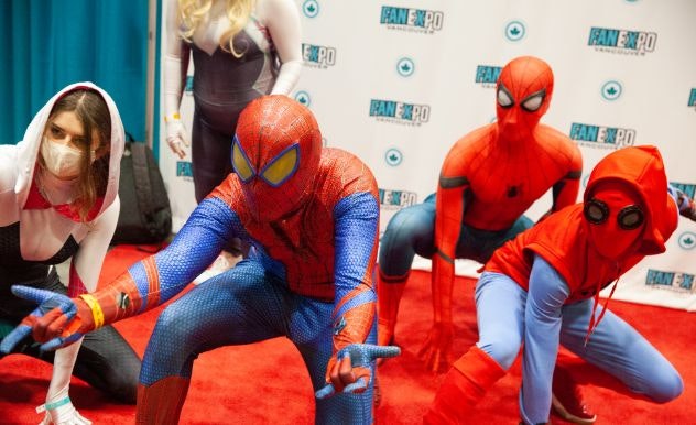 Multiple variants of Spider-Man pose together on the Cosplay Red Carpet
