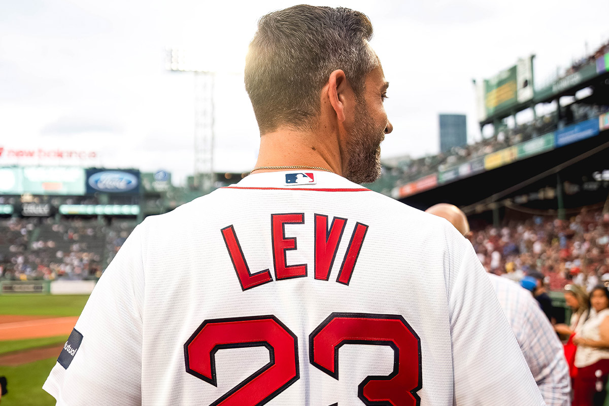 Zachary Levi faces away from the camera, showing off a custom Levi jersey
