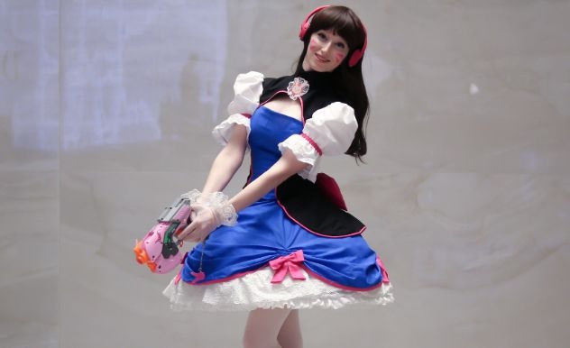 Victoria Rose in a blue and white dress with pink headphones