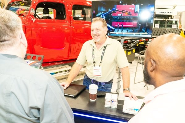 Attendees having a conversation on the WasteExpo show floor