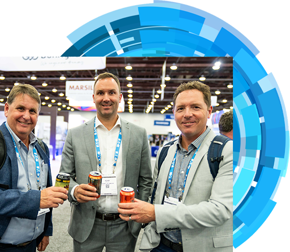 Three men dressed in suits are seen holding drinks at an event, capturing a moment of networking and conversation