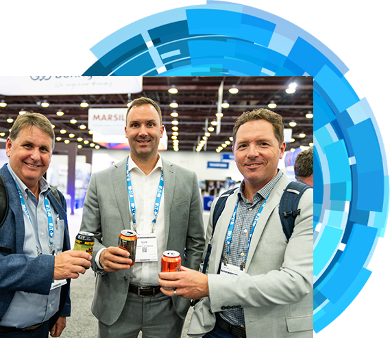 Three men dressed in suits are seen holding drinks at an event, capturing a moment of networking and conversation