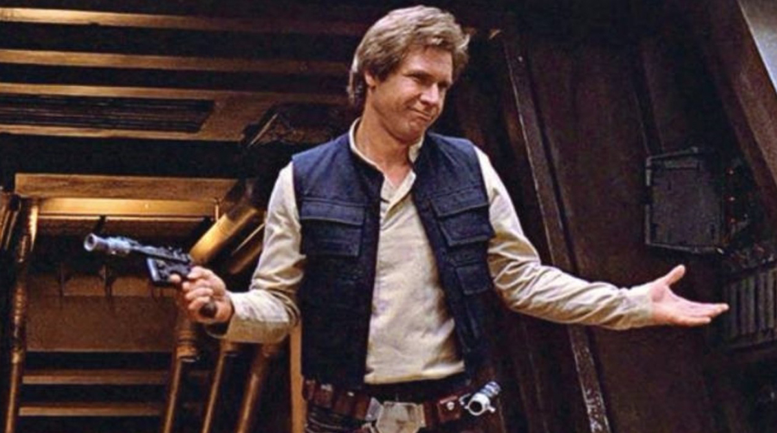 Han Solo from Star Wars holds a gun and shrugs sarcasticly