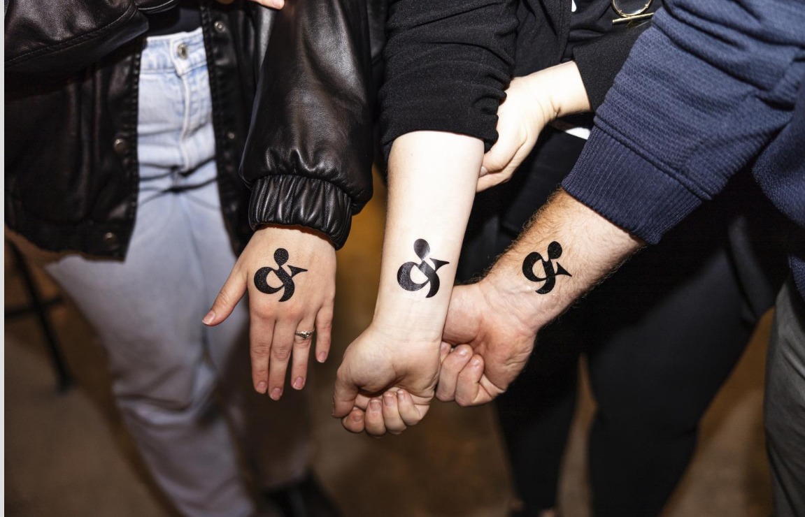 event guests with logo tattoo