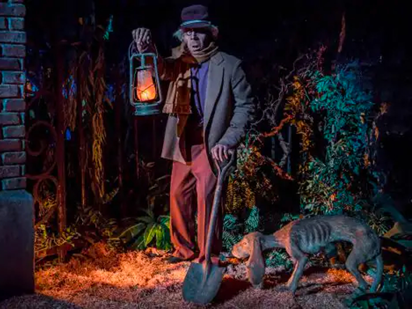 A caretaker and his thin dog holding a light lamp