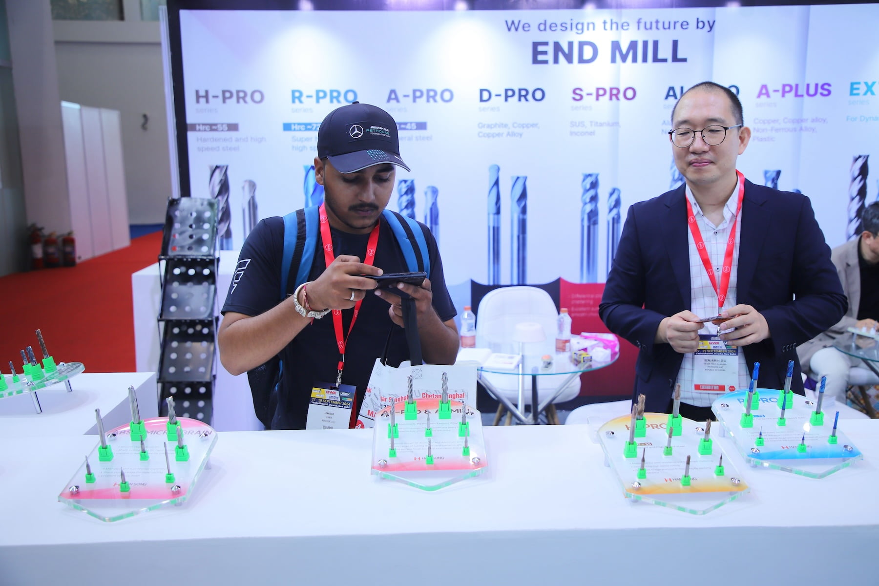 Visitor and exhibitor at end mill cutting tools booth with carbide samples on display at Tools & Equipment Expo