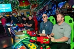 2 men playing laser shooting game at the WasteExpo
