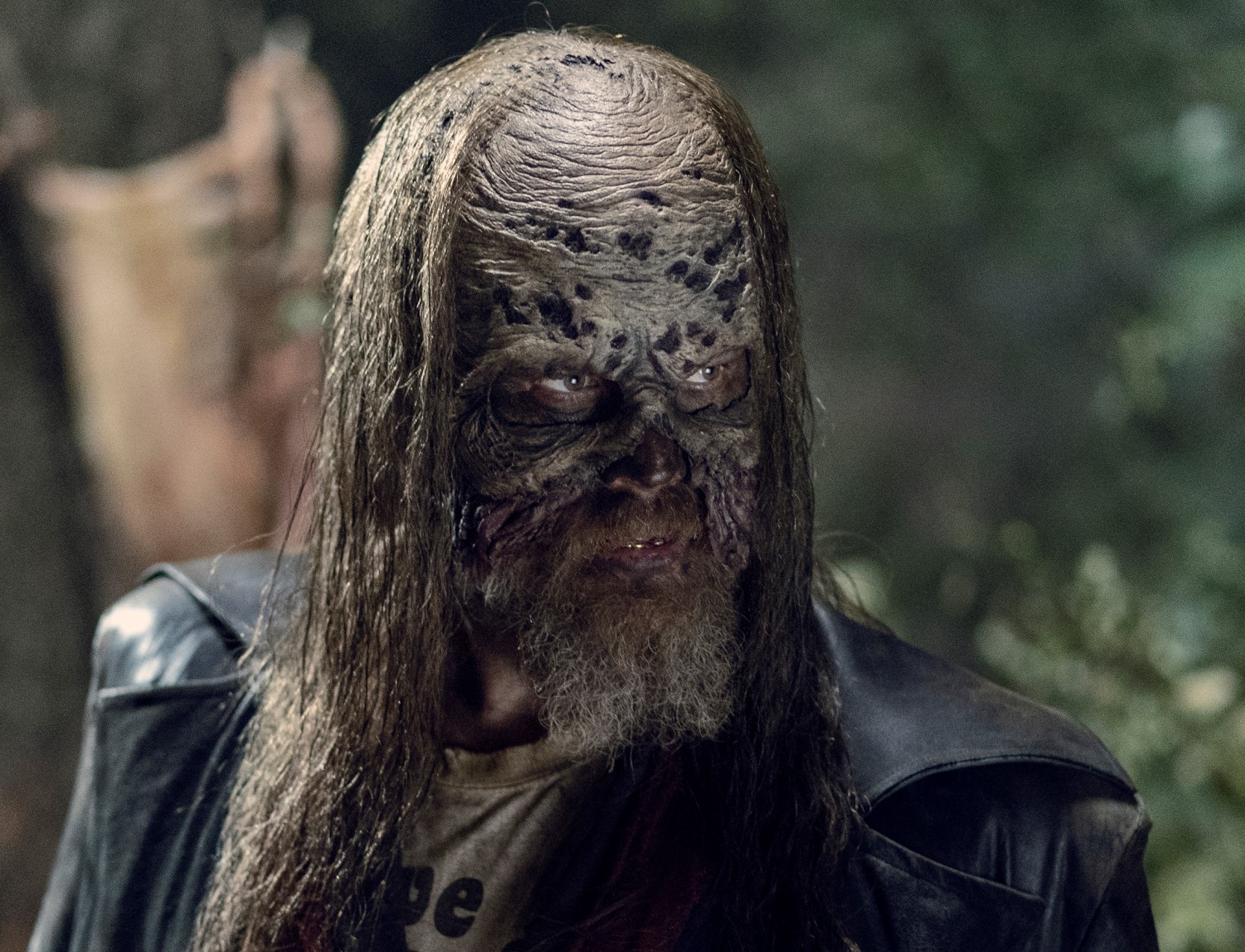 Ryan Hurst wearing a skin mask and a leather jacket.