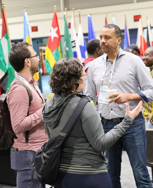 3 international attendees discussing busines in our international reception area