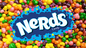 The nerds logo (blue and white) sits on top of a background of the famous candy pebbles. They colours include: yellow, pink, orange, purple, and green.