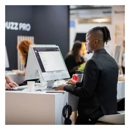 black man with dreadlock looking at laptop screen