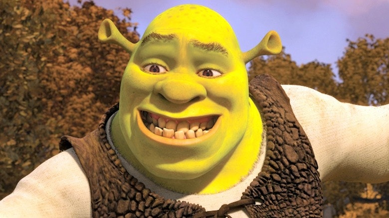 Shrek smiles at Donkey, they are in the swamp.