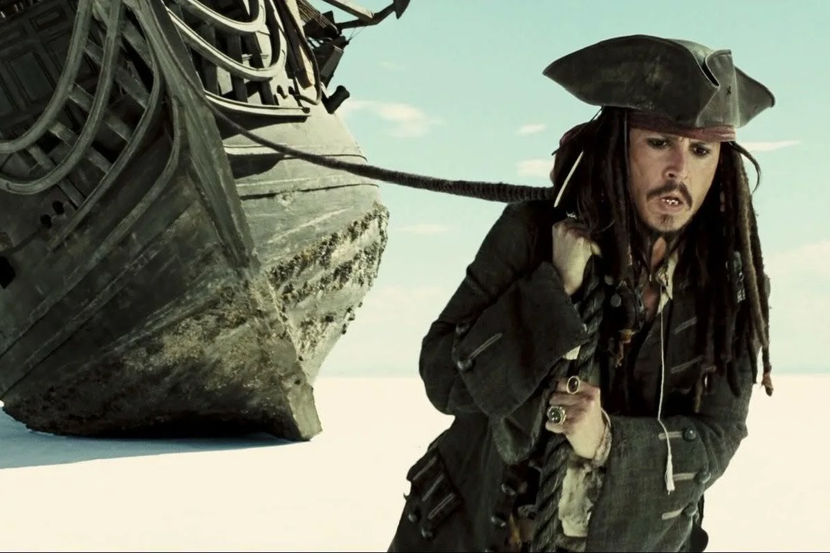 Jack Sparrow pulls a cord attached to the Black Pearl